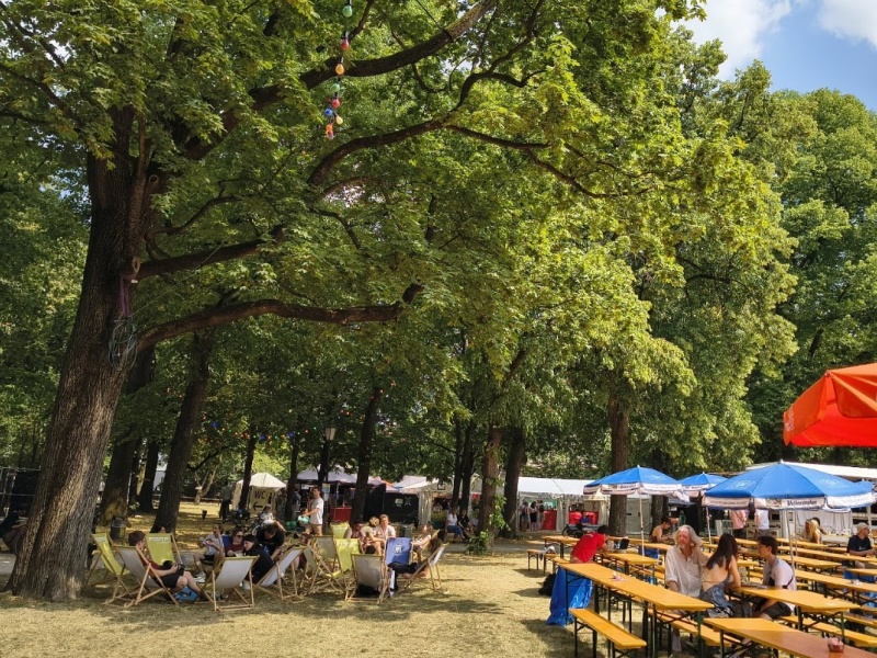 Tunix Festival mit Biergarten unter alten Bäumen
